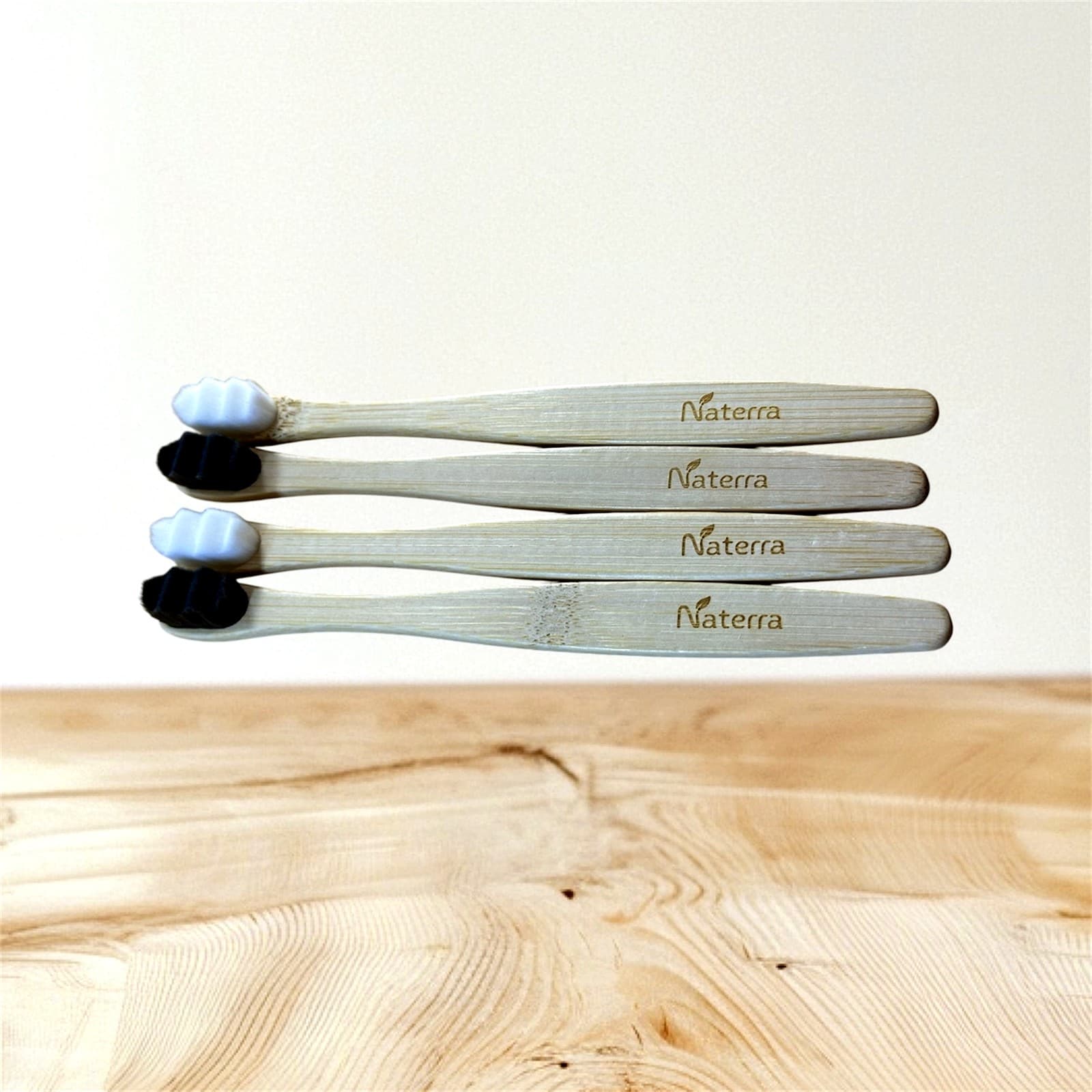 Set of four Naterra Bamboo Toothbrushes, two with white and two with black bristles